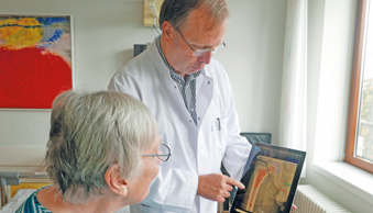 Bild Siloah St. Trudpert Klinikum, OUC, Arzt zeigt Patientin ein Roentgenbild auf einem Tablet